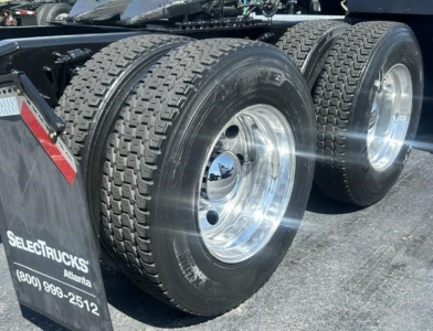 Freightliner Cascadia 126 rear dual rear wheels showing chrome polished rims and heavy-duty tires.