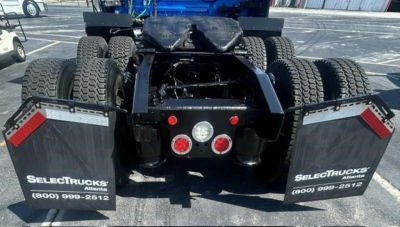 Rear view of a 2022 Freightliner Cascadia 126 tractor showing fifth wheel area, dual rear axles, and mud flaps with SelectTrucks branding.