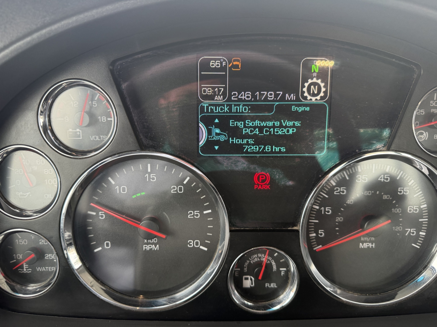 Kenworth T680 instrument cluster with digital truck info display showing engine hours and mileage, gauges for RPM and speed, and warning icons.