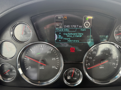 Kenworth T680 instrument cluster with digital truck info display showing engine hours and mileage, gauges for RPM and speed, and warning icons.