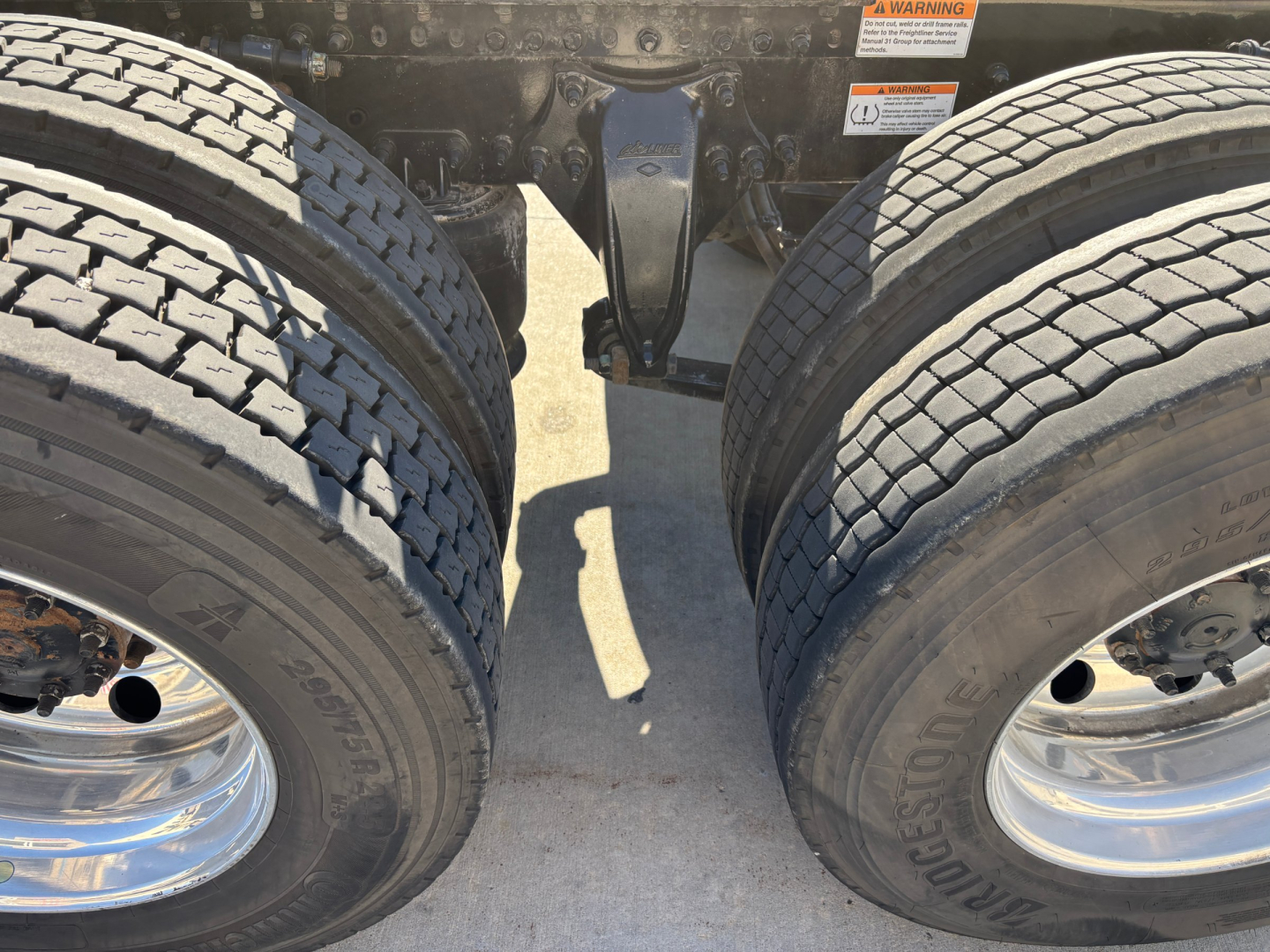 Freightliner PT126064ST rear chassis and dual rear axles showing tires and suspension components.
