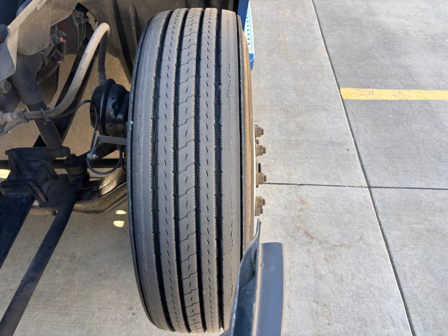 Wheel view of Freightliner PT126064ST with front dual tires and suspension components visible
