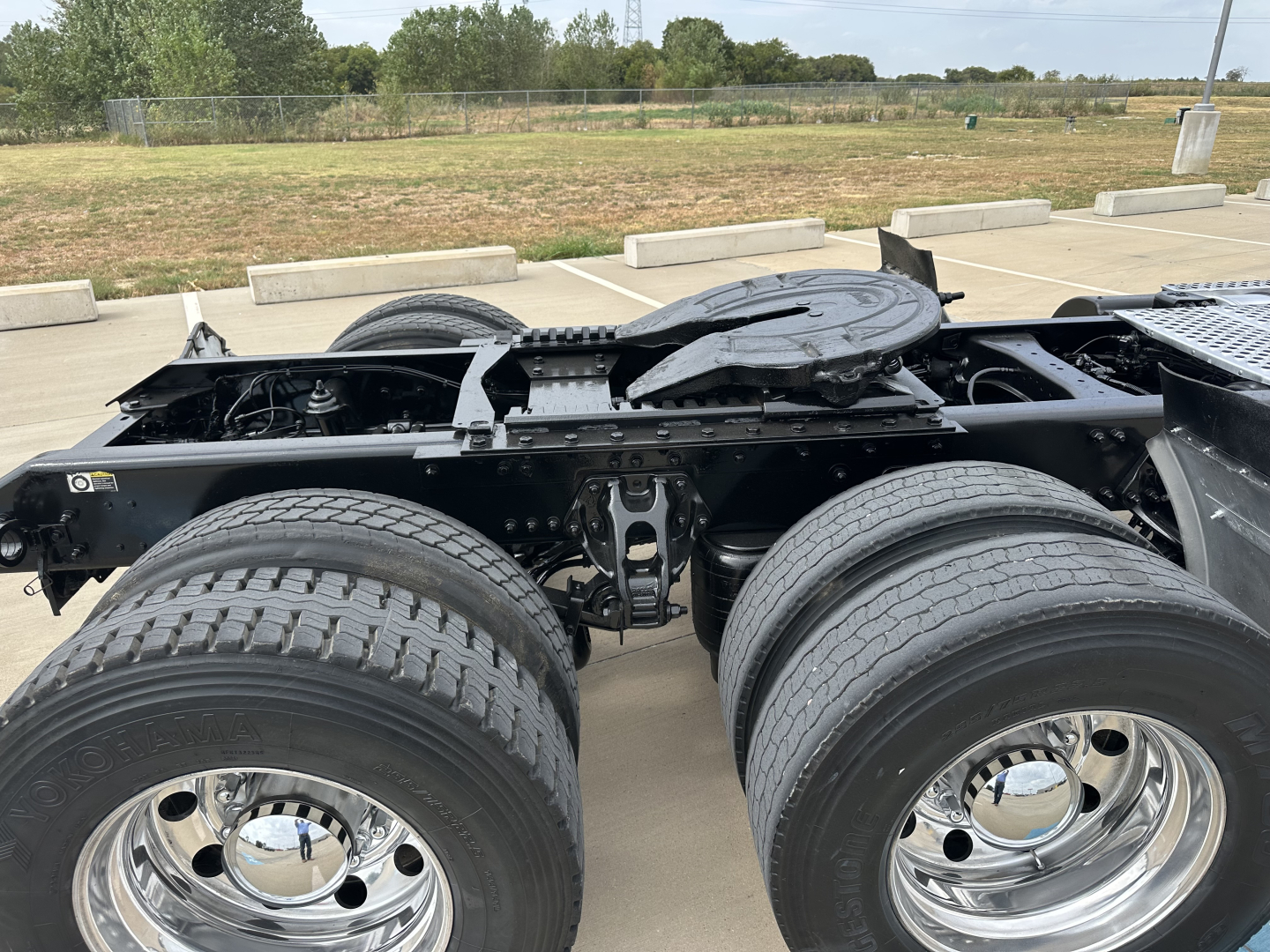 Kenworth T880 chassis showing dual rear axles and fifth wheel area, with dual rear tires and chrome wheels.