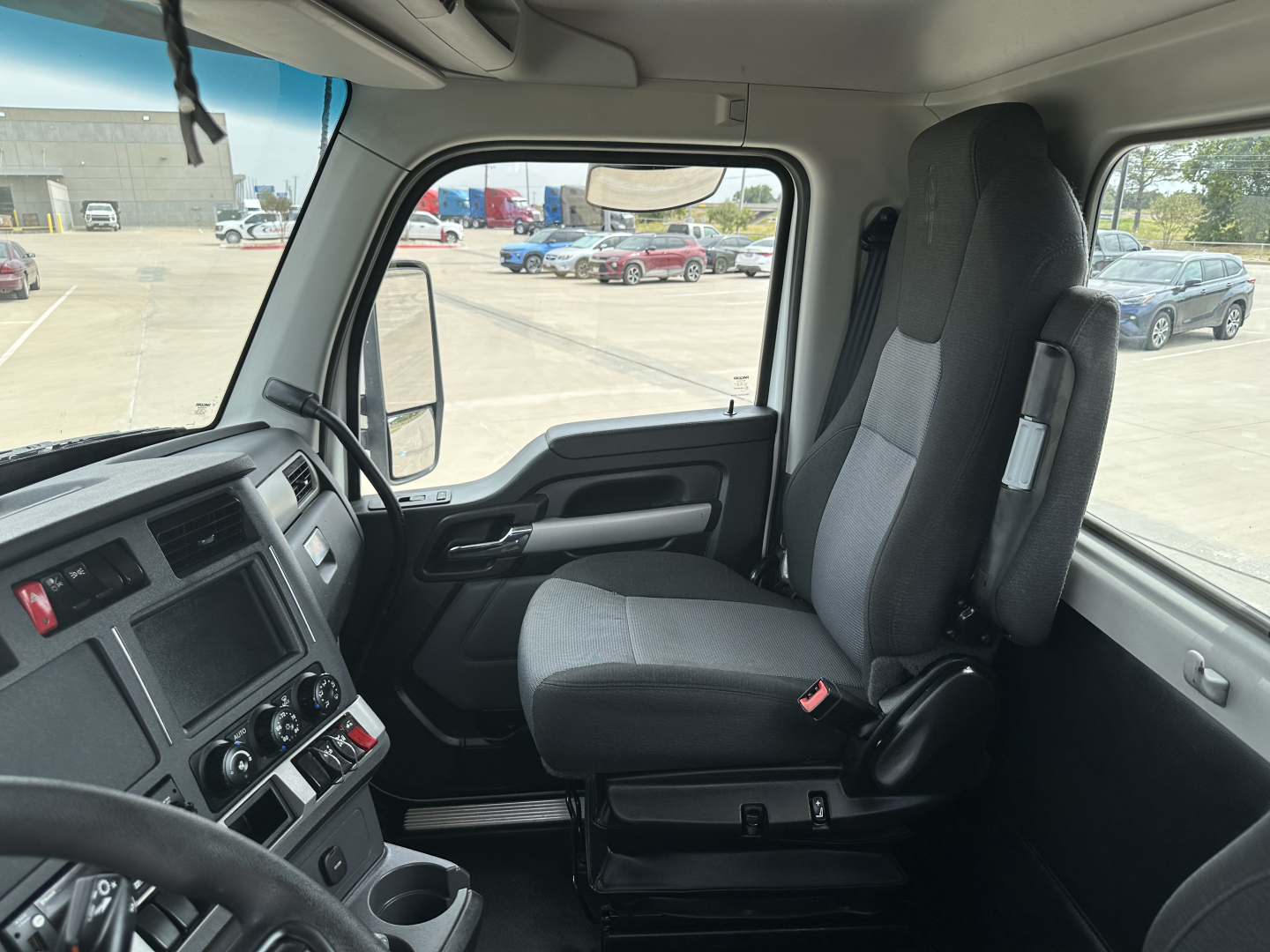 Kenworth T880 cab interior showing driver seat and dashboard details