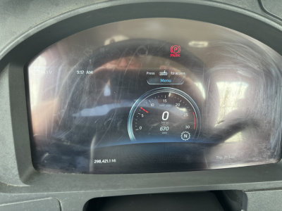 Dashboard of a Kenworth T880 showing digital gauges, mileage 298,421.1 mi, gear indicator, and parking indicator; center display shows 0 mph, engine status, and Menu prompt.