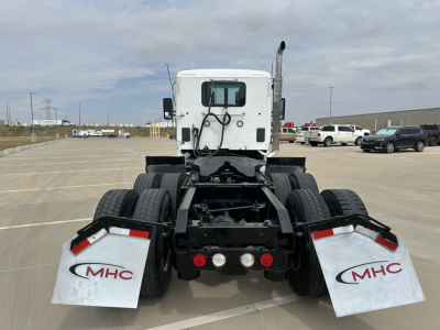 Kenworth T880 cab and chassis rear view showing mudflaps with MHC logos and rear lights.