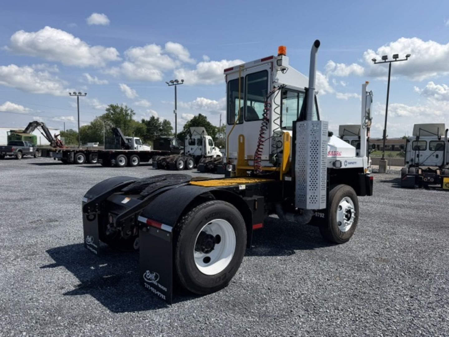 Truck cab and chassis of a capacity Sabre DOT yard truck showing rear fenders, tires, and side exhaust with vertical silencer.