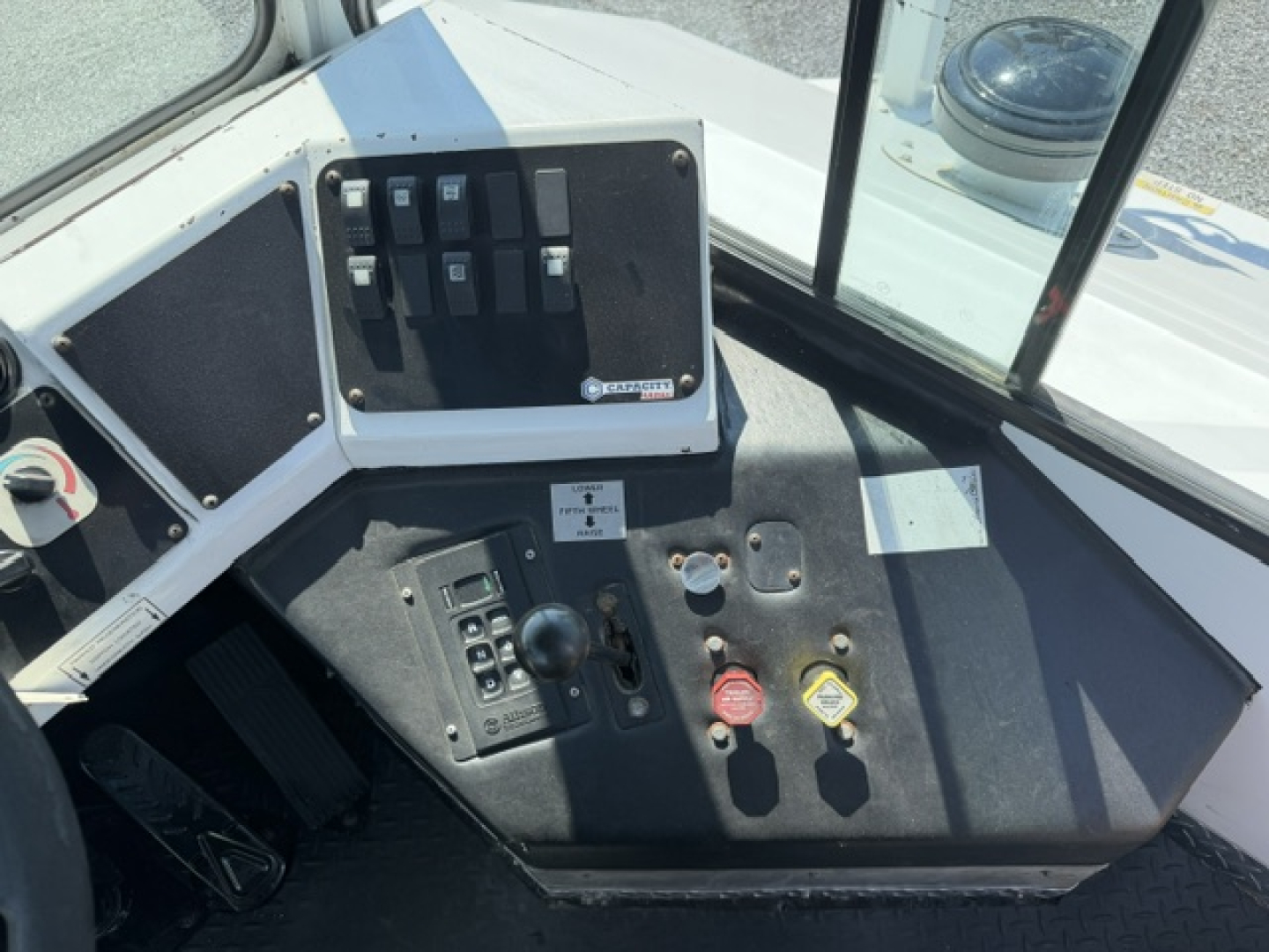 Dashboard view of a 2020 Capacity Sabre DOT yard truck showing switch panel, gauges, and red/yellow warning buttons.