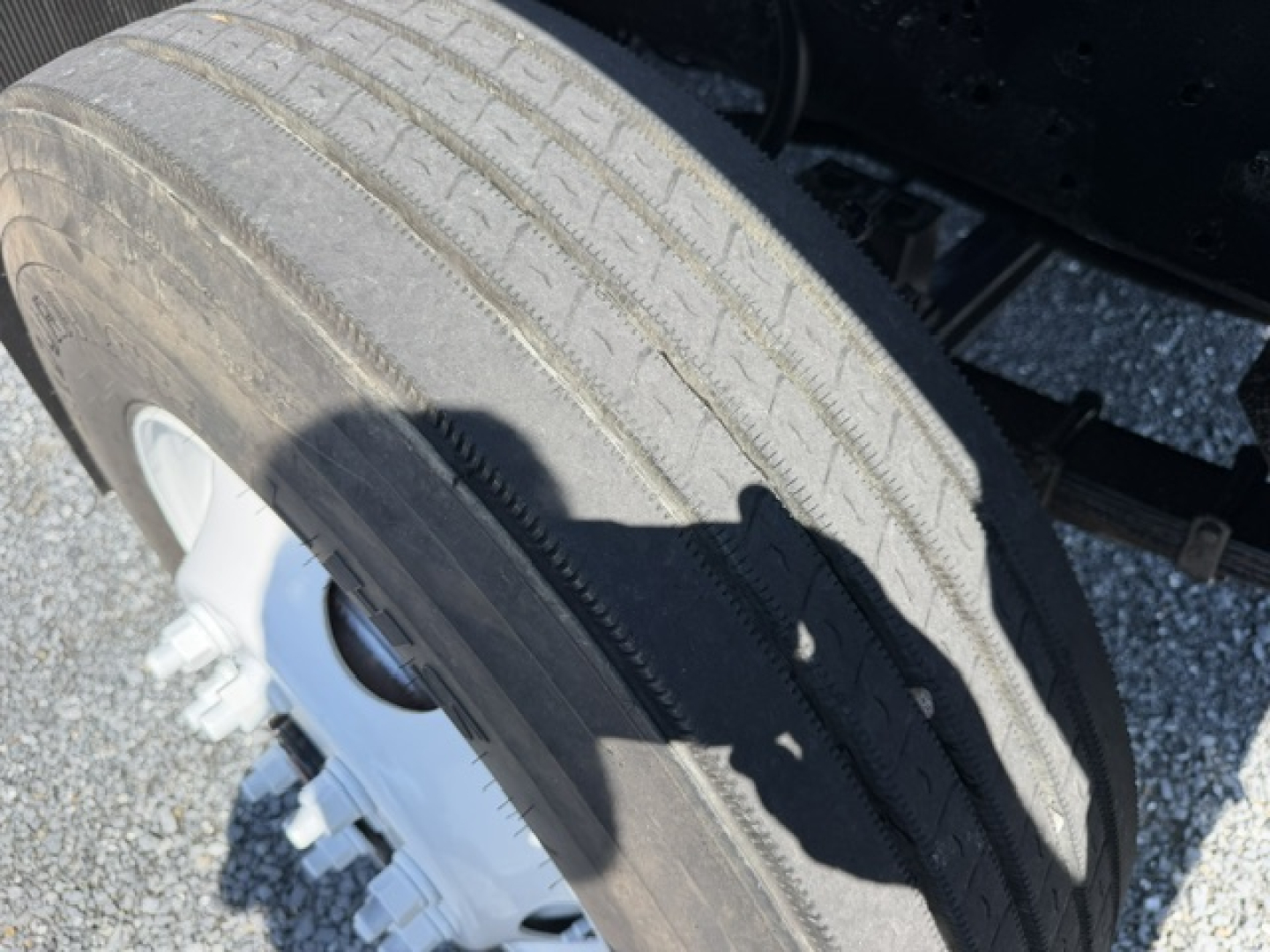 Wheel and tire view of a used Capacity Sabre DOT truck showing a large treaded tire and steel wheel, part of the rear axle assembly.