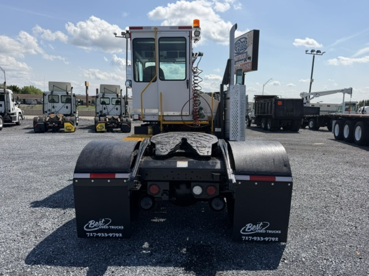 Rear view of a 2020 Capacity Sabre DOT truck tractor in yard, showing back of cab, dual fenders, and rear underrun area with lights and decals.