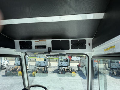 Interior cab view of a 2020 Capacity Sabre DOT truck showing dash area, overhead panels, and driver’s side window with yard equipment visible outside.