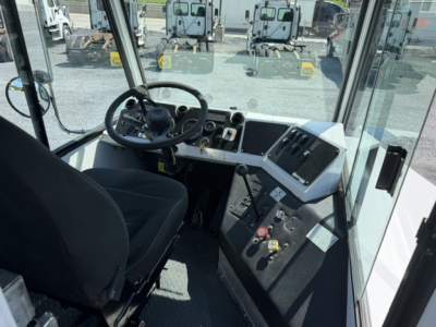 Cab interior of a Capacity Sabre DOT yard truck showing steering wheel, control panel, gauges, and pedals.