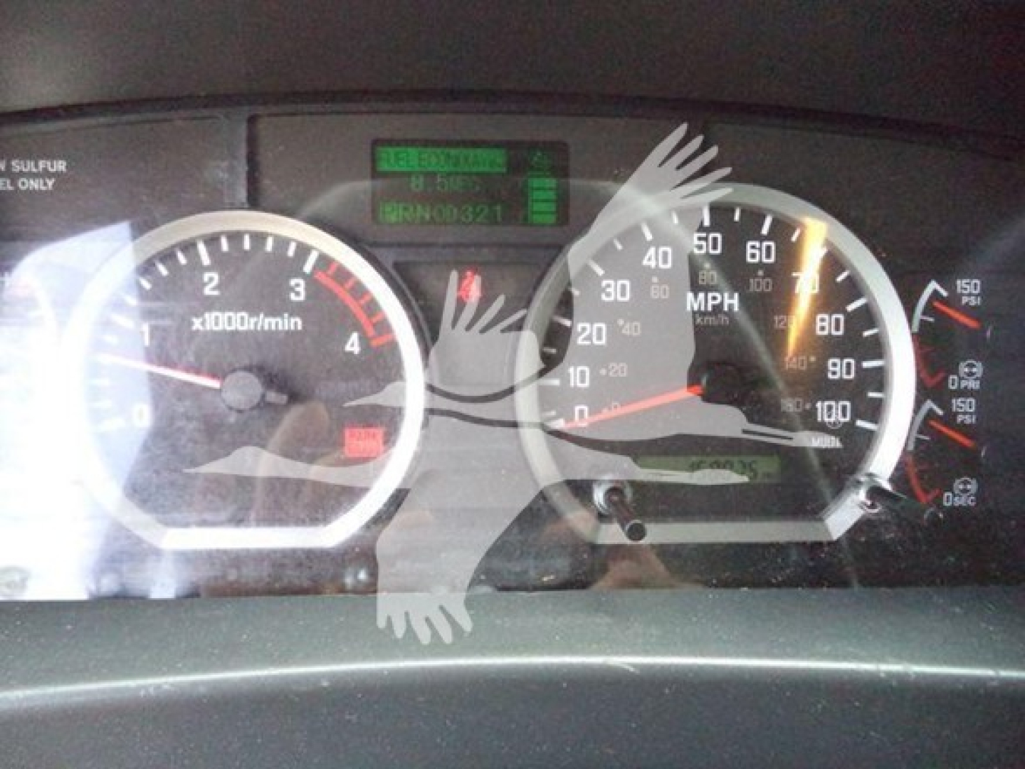 Dashboard of Isuzu truck showing tachometer (x1000 r/min), speedometer up to 100 mph, and digital display with BRN0 0321? and other indicators.