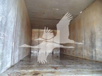 Isuzu chipper truck cargo area with a large watermark image of a bird and hands overlayed; no readable model text or labels visible inside the trailer.