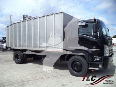 Isuzu FTR dump truck side view showing large metal dump body and black cab.