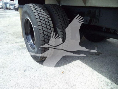 Isuzu FTR truck rear wheel and undercarriage with dual rear tires and chassis visible.