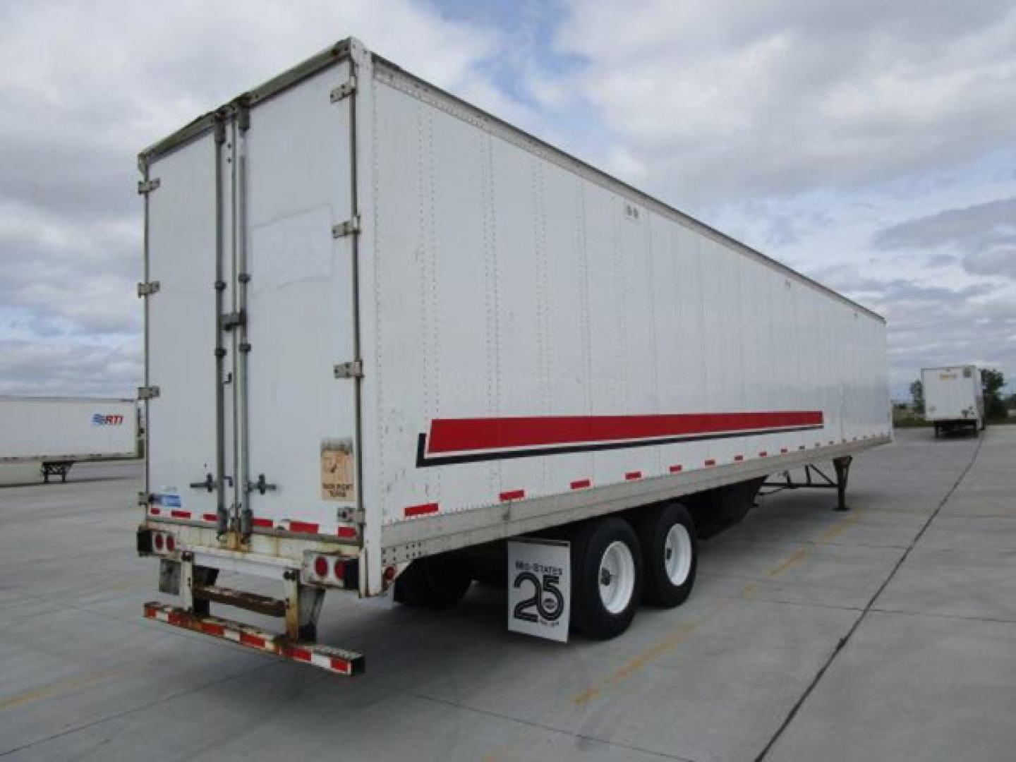 Stoughton 2014 van trailer showing side view with white exterior and red accent stripe, dual rear wheels, and rear doors.