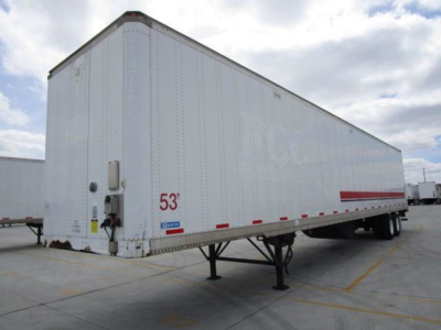 Trailer side of a 2014 Stoughton van trailer showing white exterior, red reflective striping, 53' length, landing gear in front, and wheel axles at rear.