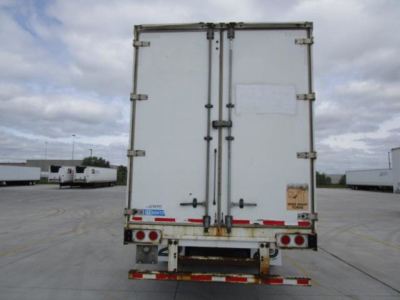 Back view of a 2014 Stoughton van trailer showing double rear doors, bumper with reflectors, and license plate area with warning sticker.