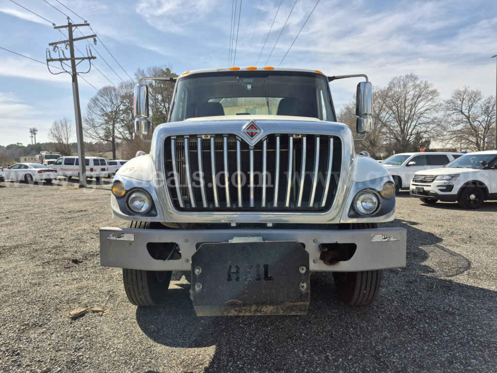 Front view of a 2017 International 7400 garbage truck with large chrome grille, bumper, and a heavy front license plate mount.
