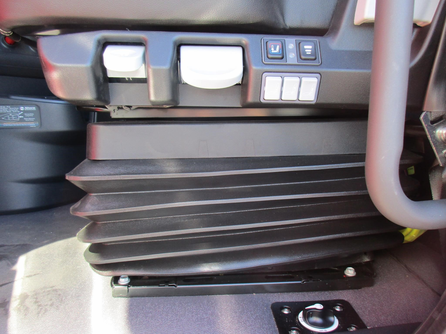 Western Star 47X cabin area showing lower air intake/plenum with accordion-style rubber boot and controls panels nearby.