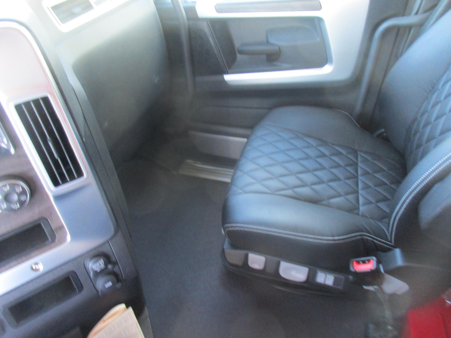 Interior of a 2027 Western Star 47X crew cabin showing black quilted seat with controls on the side panel.
