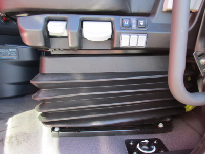 Western Star 47X cabin area showing lower air intake/plenum with accordion-style rubber boot and controls panels nearby.