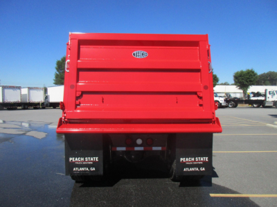 Back of red dump truck bed with TEIBCO logo and black mudflaps showing Peach State Atlanta GA text.