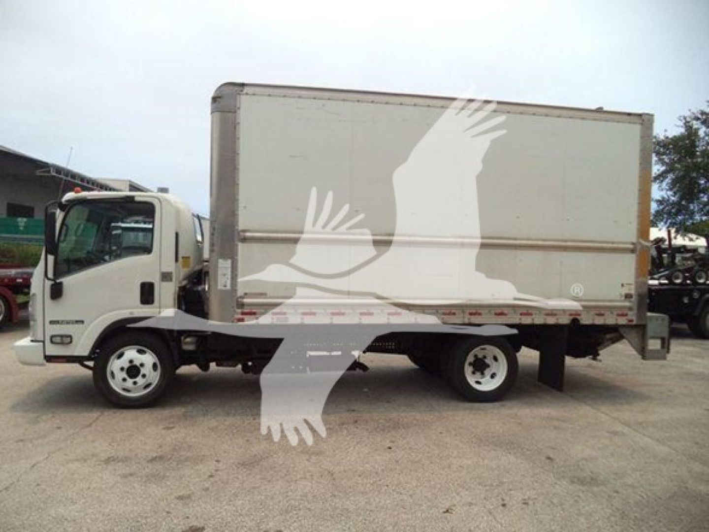 Isuzu NPR HD box truck side view showing cargo box and cab with stock number T02668