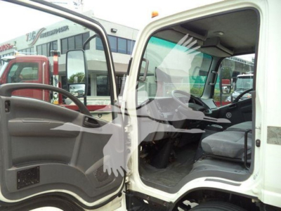 Isuzu NPR HD cab interior and open driver door showing steering wheel and dashboard.