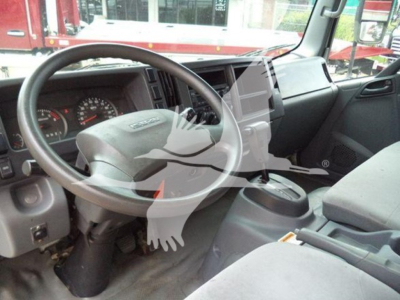 Isuzu NPR-HD interior with steering wheel and dashboard view showing center console and dashboard gauges.