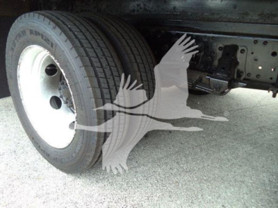 Isuzu NPR HD truck wheel assembly showing front dual tires and chassis with underbody components.