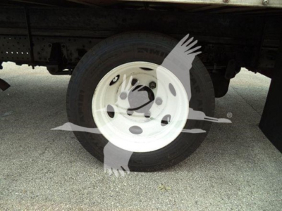 Isuzu NPR HD truck wheel and tire visible under chassis with white steel wheel.
