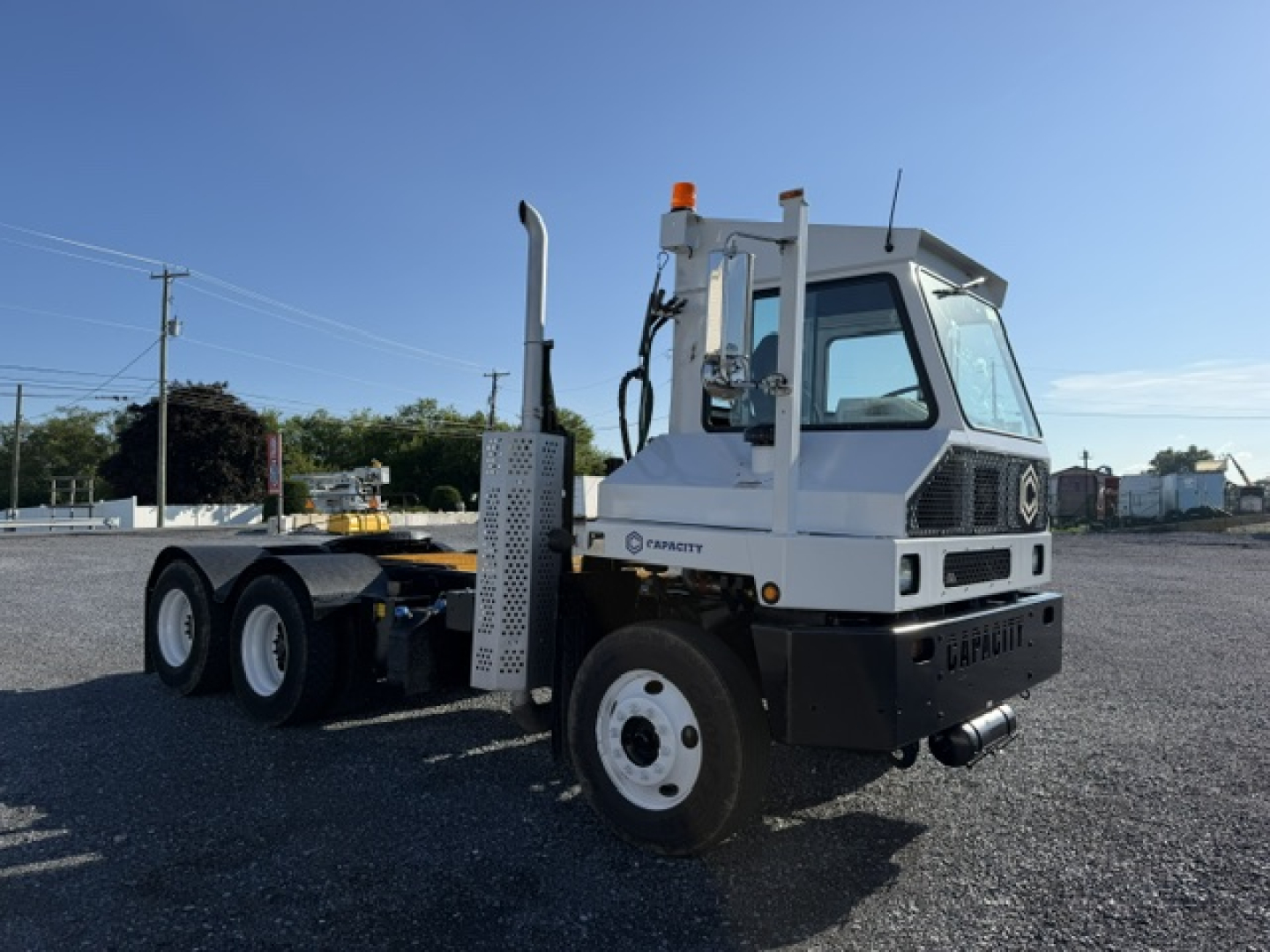 Capacity TJ6500 DOT truck showing cab and chassis with white body, visible exhaust stack, and front bumper; no legible model text on image.