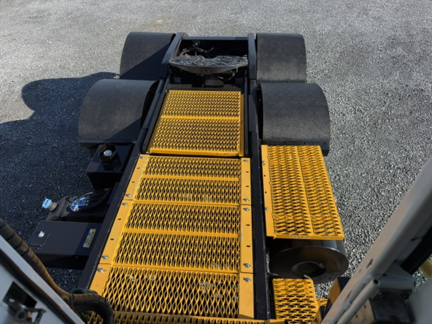 Capacity TJ6500 yard truck platform with yellow safety steps/plates and black guards, view of entry steps and rear chassis.