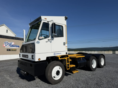 Tractor unit cab of a 2019 Capacity TJ6500 DOT truck showing a white cab, side step, and dual rear axle chassis with black bumper and large tires.