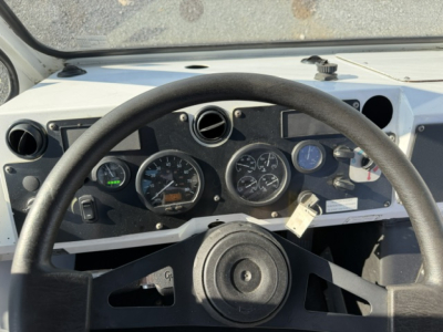 Dashboard and steering wheel of a TJ6500 truck showing gauges and controls. Visible text on dashboard includes various dials; no legible model or fluid labels clearly readable.