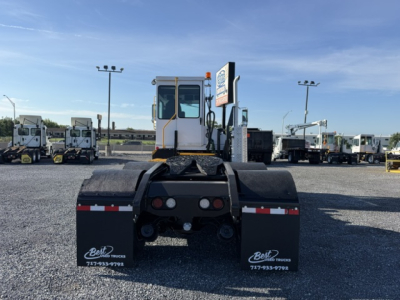 Capacity TJ6500 DOT yard truck rear view showing mud flaps, chassis, and rear hitch area.
