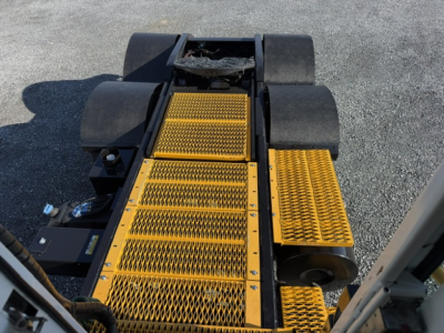Capacity TJ6500 yard truck platform with yellow safety steps/plates and black guards, view of entry steps and rear chassis.