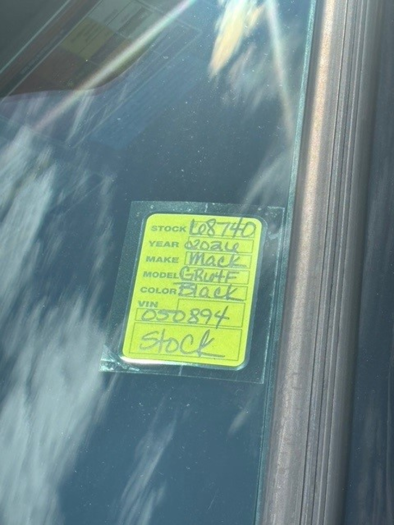 Stock sticker on Mack truck window showing stock number 68740 and VIN 1M2GR4GC1TM050894.