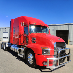 Mack AN64T70 heavy duty truck in red color with chrome bumper and sleeper cab, front three-quarter view.