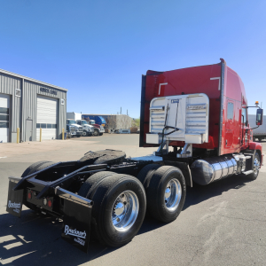 Mack AN64T70 heavy truck tractor chassis rear view showing dual rear axles and red sleeper cab
