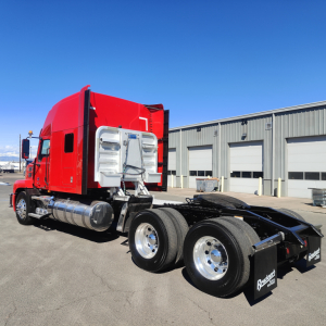 Truck tractor side view showing red sleeper cab and chrome fuel tanks, dual rear axles, and fifth wheel without visible company branding.
