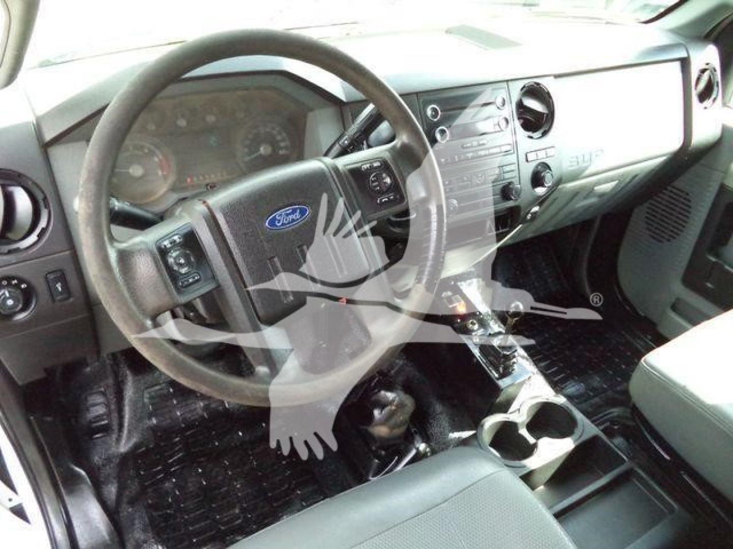 Ford F-650 interior showing steering wheel and dashboard with center console and cup holders.