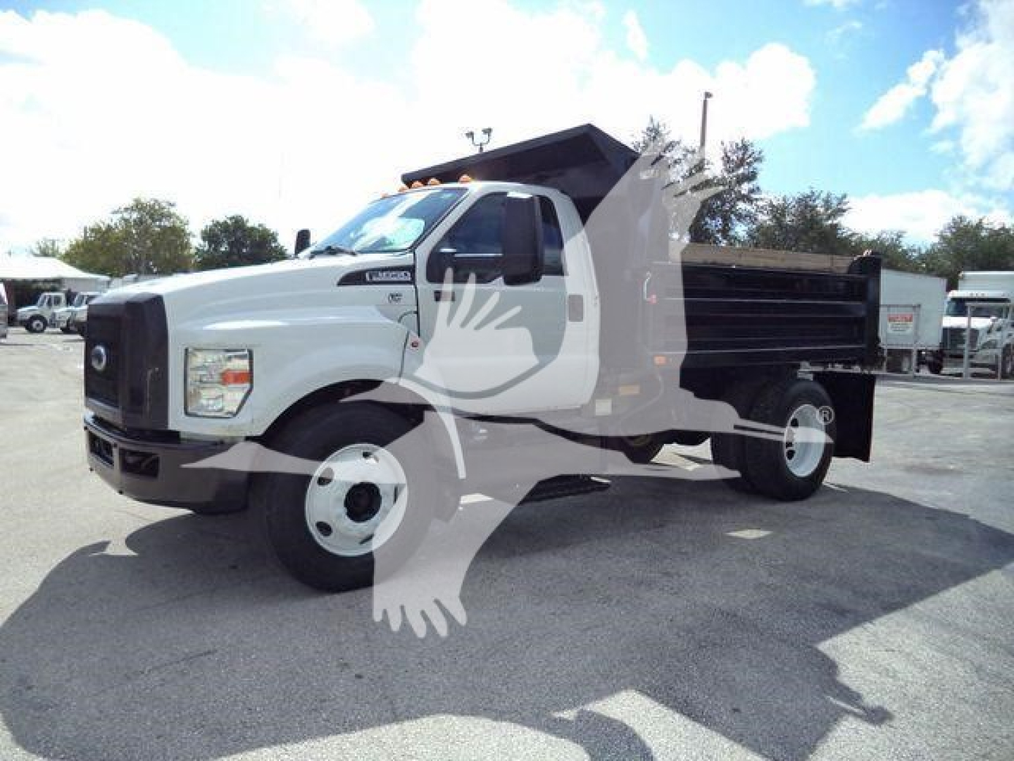 Dump truck 2017 Ford F650 XL SD side view showing dump bed and black utility bed with white cab