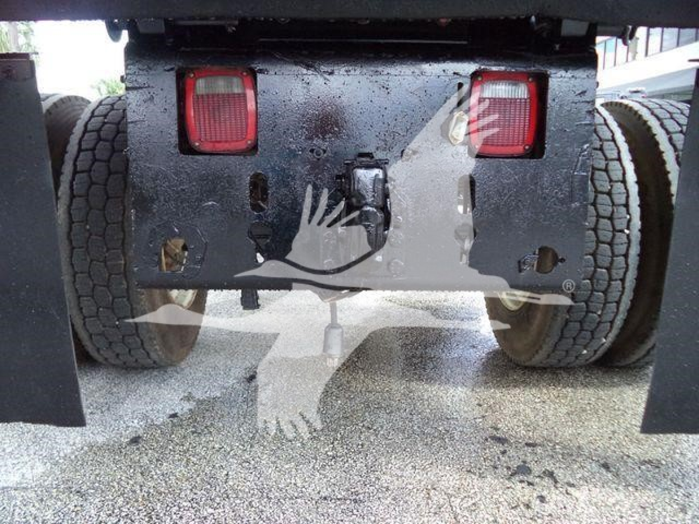 Truck rear view showing hitch area and dual rear lights of a 2017 Ford F650 XL SD dump truck. Visible are taillights, bumper plate, and rear wheel wells.
