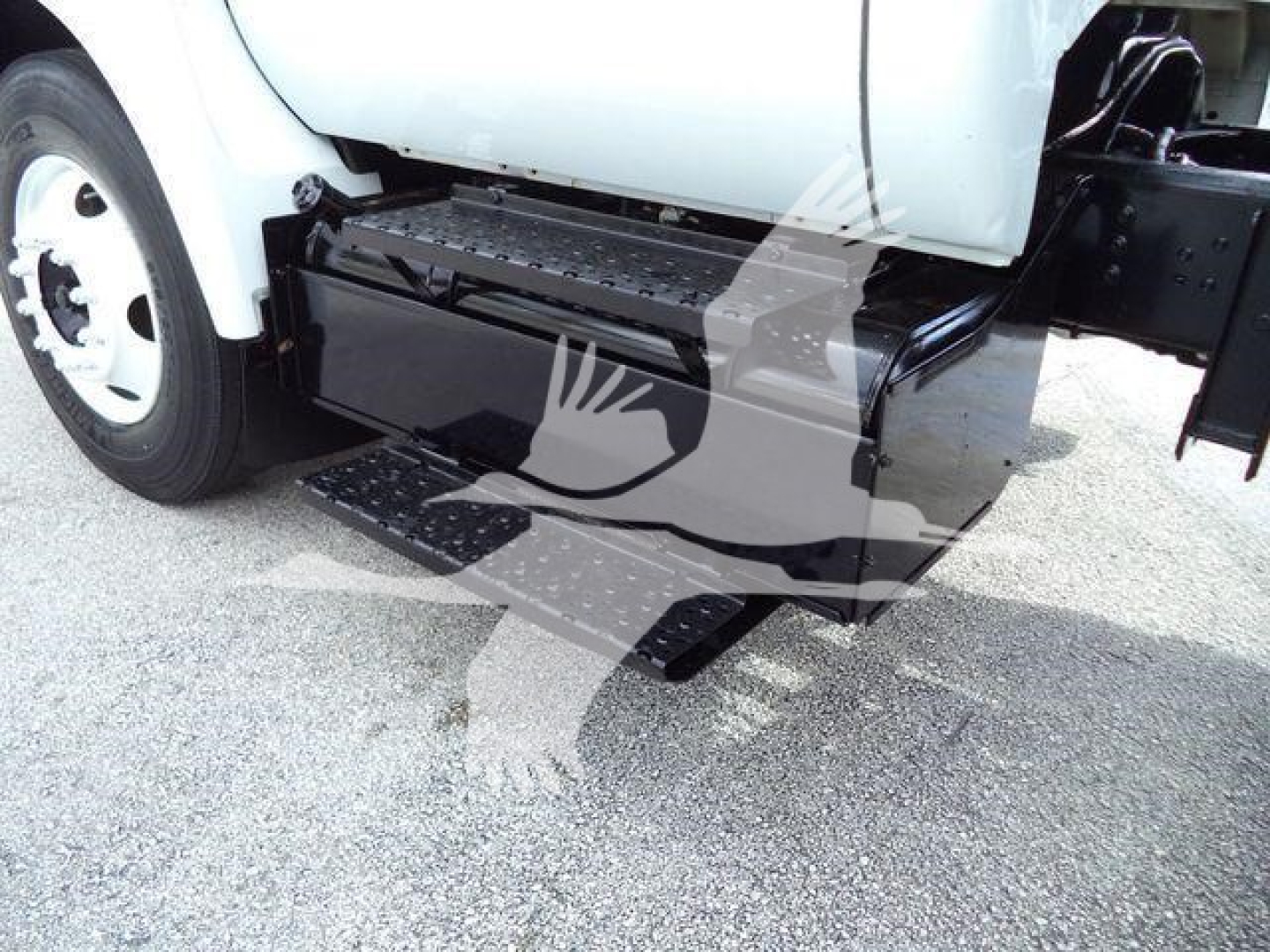 Truck side view showing black rectangular side step and underbody storage box on 2017 Ford F650 XL SD dump truck.