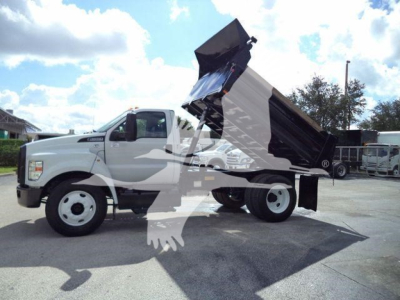 Dump truck 2017 Ford F650 XL SD side view showing raised dump bed and hydraulic system.
