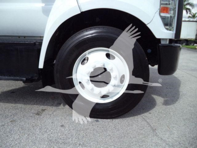 Front left wheel of a 2017 Ford F650 XL SD dump truck showing the front tire and white wheel with partial fender, no visible text.