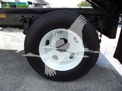 Wheel and tire assembly on a Ford F650 XL SD dump truck showing white steel wheel